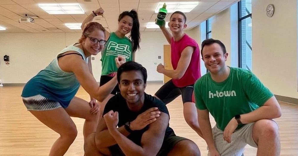 group of five people huddled together in strength poses