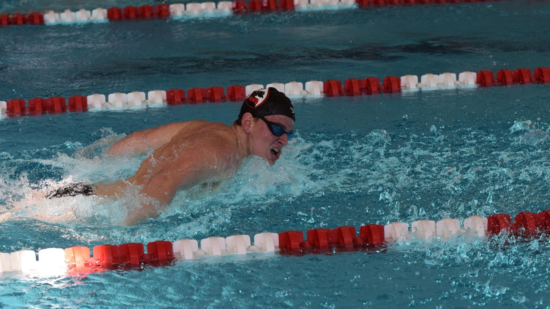 side profile of a men's swimmer doing butterfly stroke