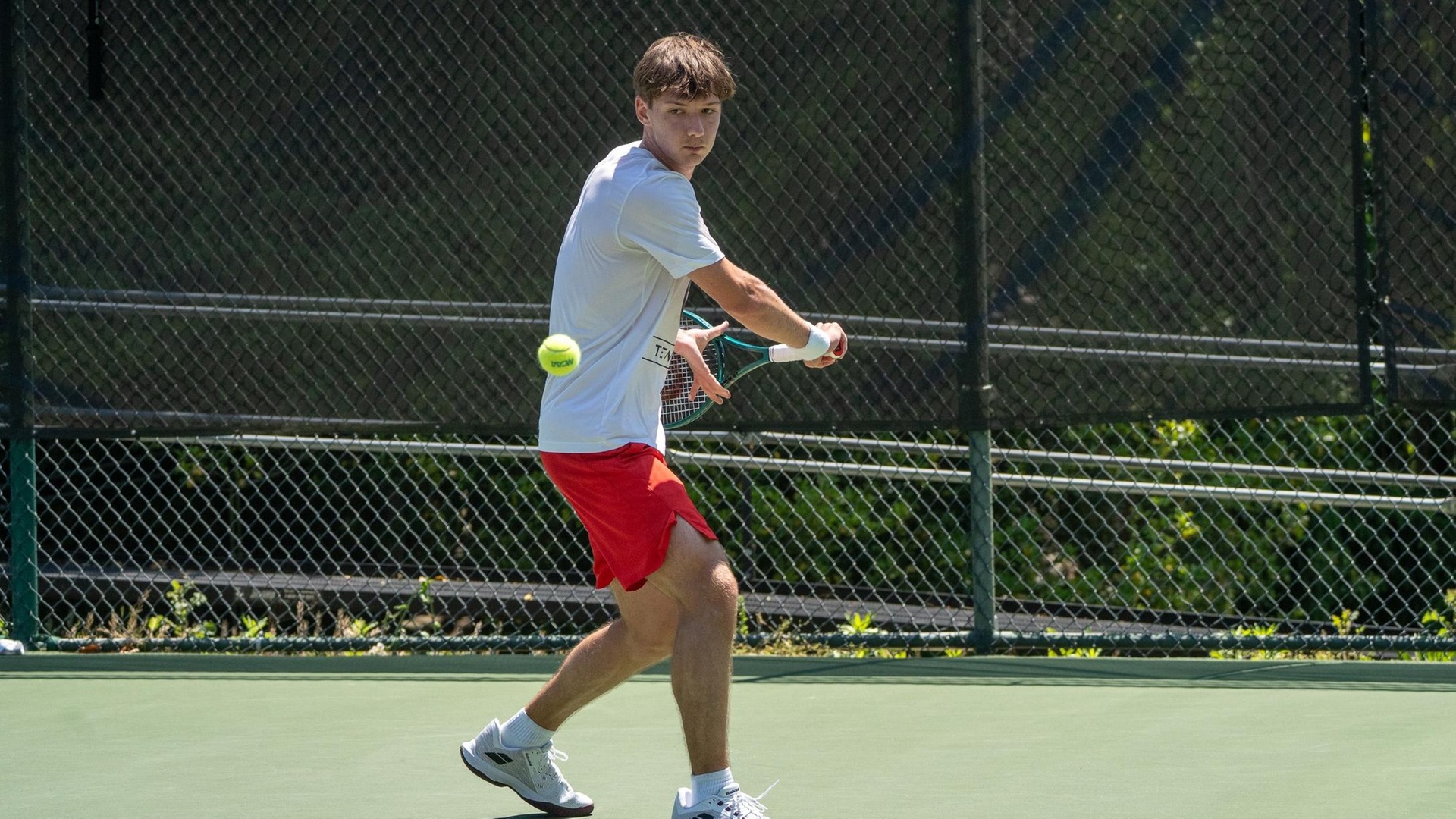 men's tennis player swinging a racquet