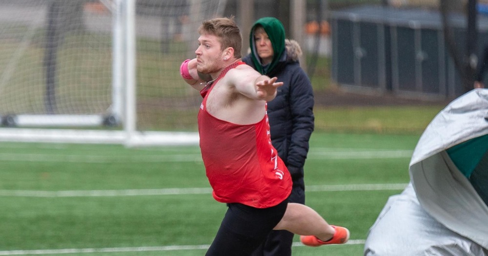 men's athlete about to throw the shot put