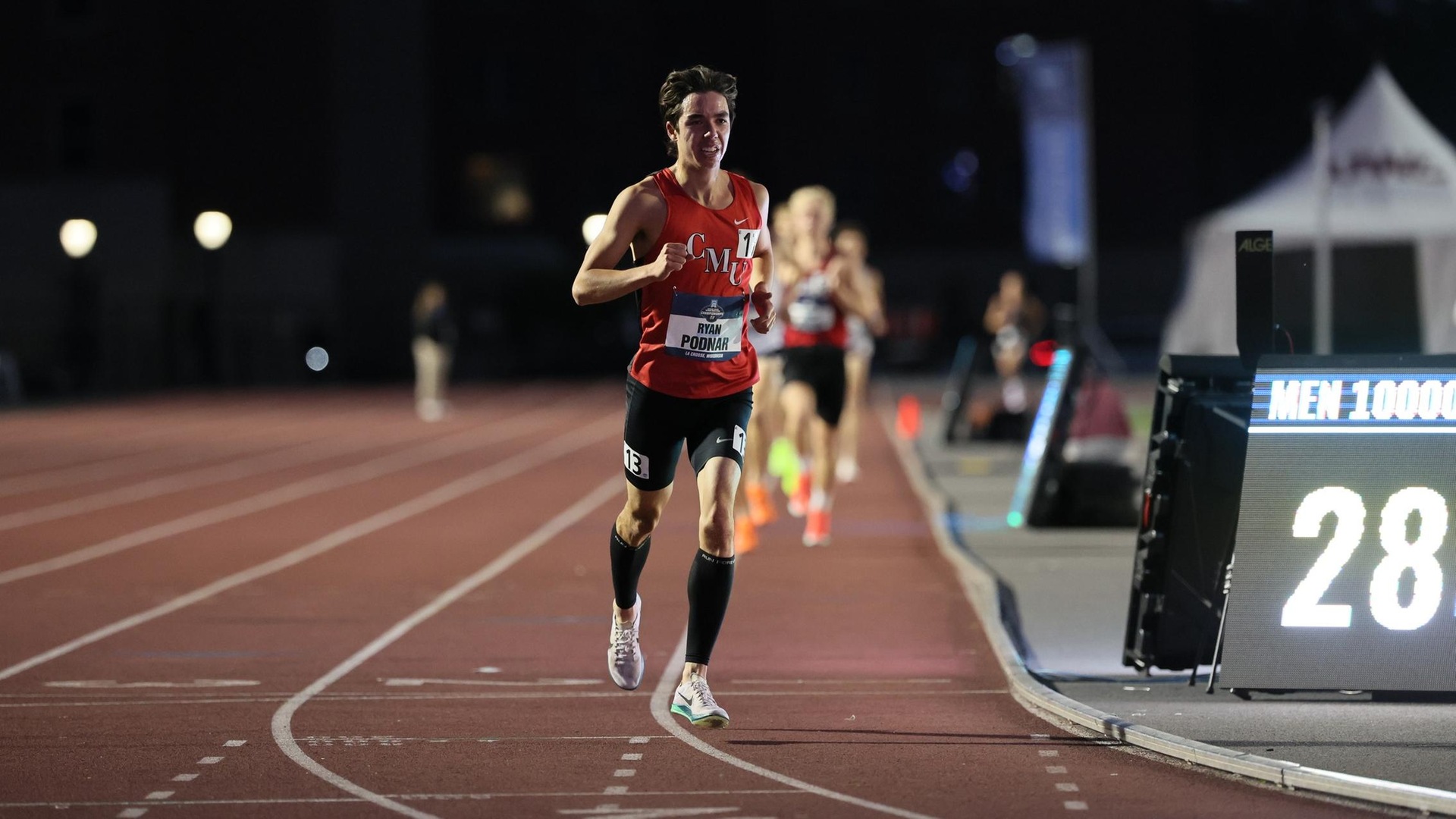 male running around a track