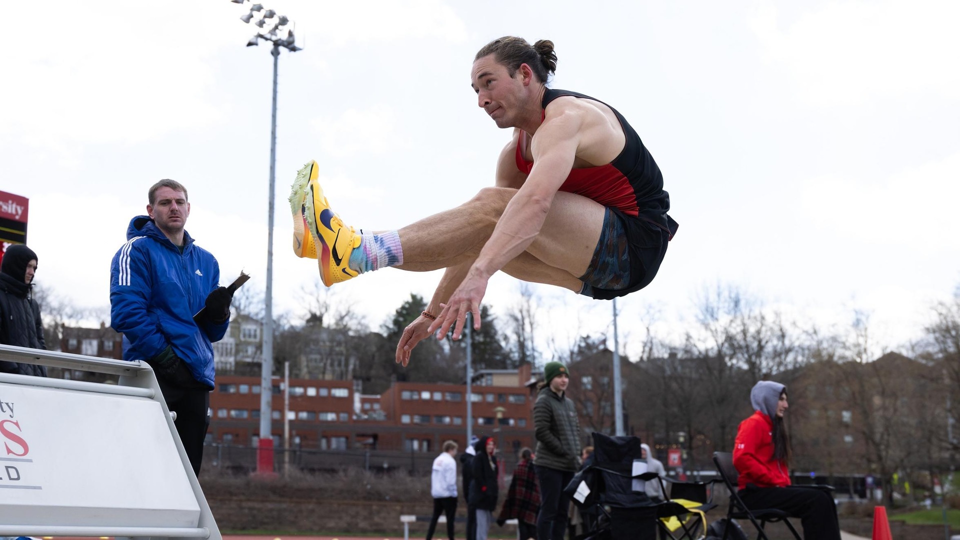 men's track athlete jumping in the air