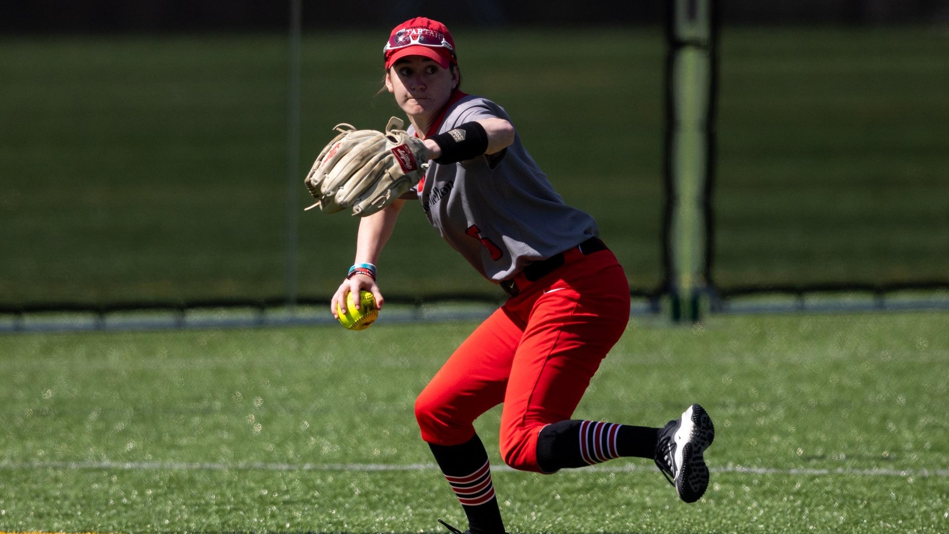 women's softball player preparing to through the ball