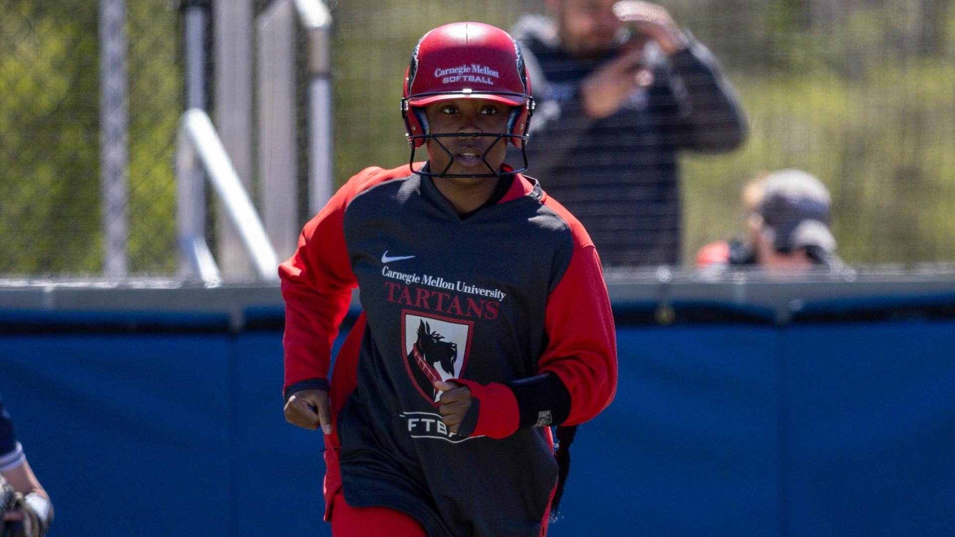 women's softball player running the bases
