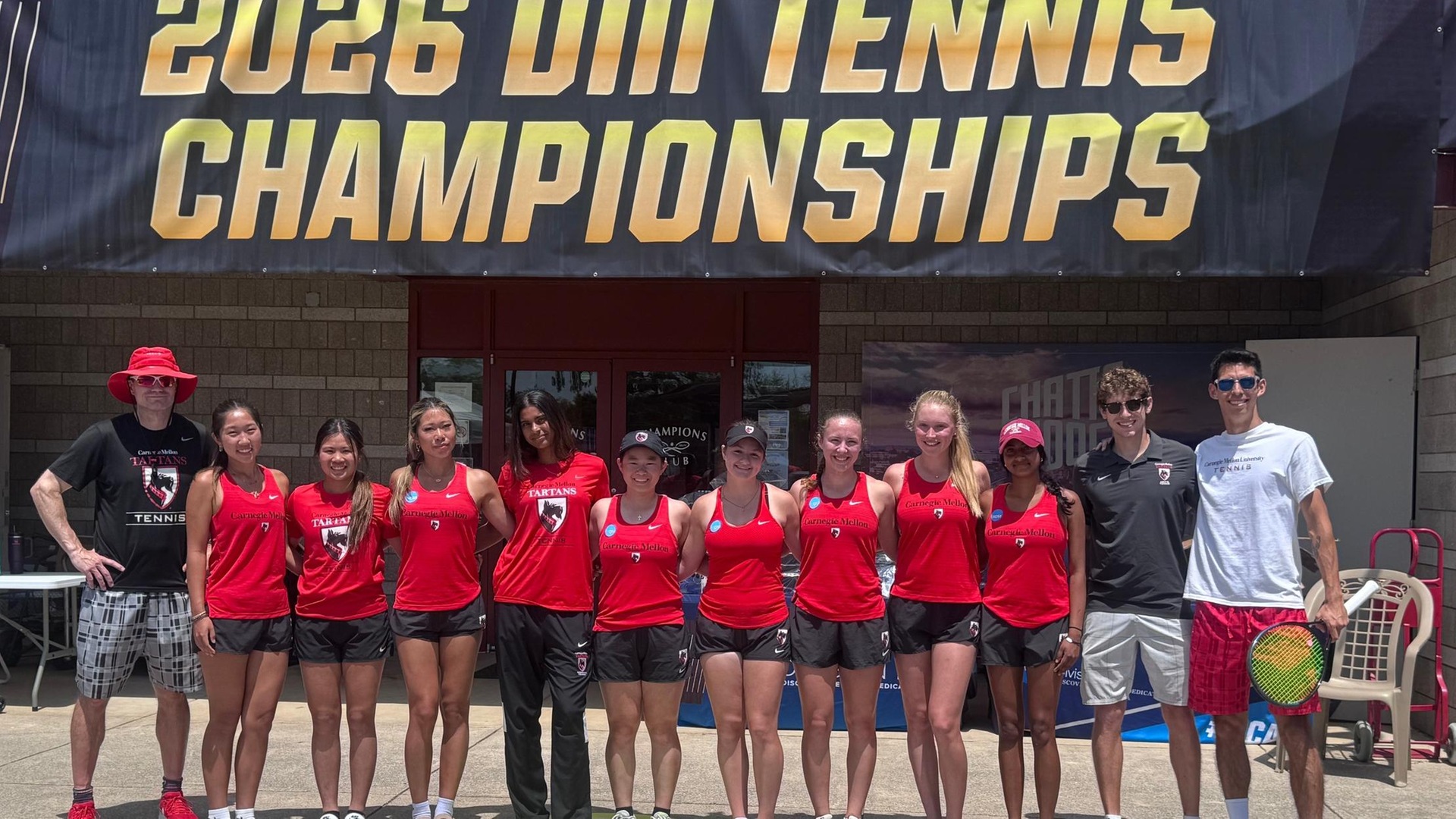 team photo of women's tennis players with banner reading 2026 DIII Tennis Championships