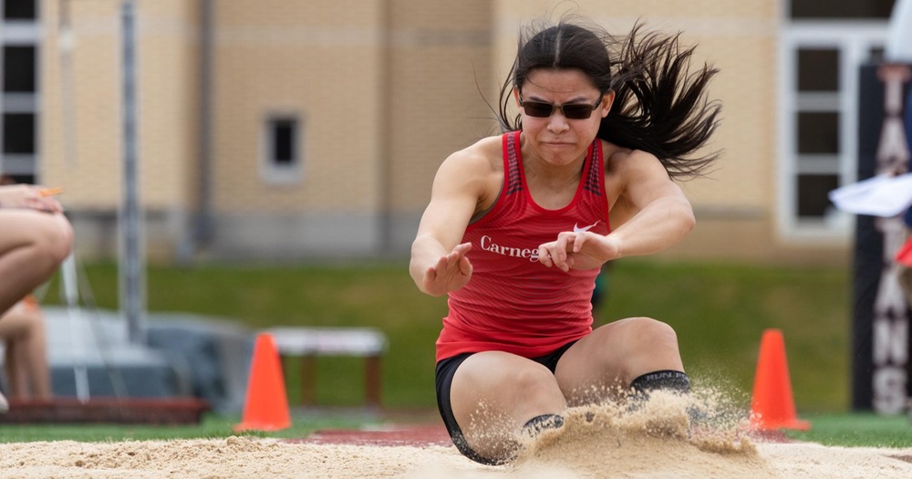 Women landing in sand pit after lump jump attempt