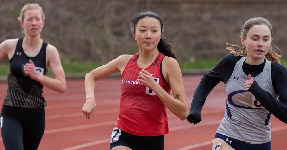 three women's track runners in a race